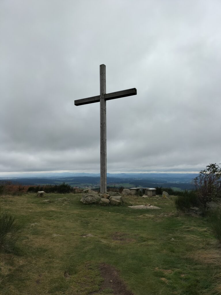 Sommet avec une croix et une vue sur les montagnes environnantes